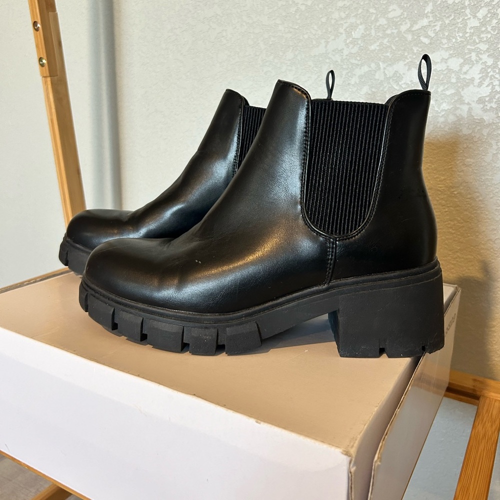 Women’s black combat boots, size 9.